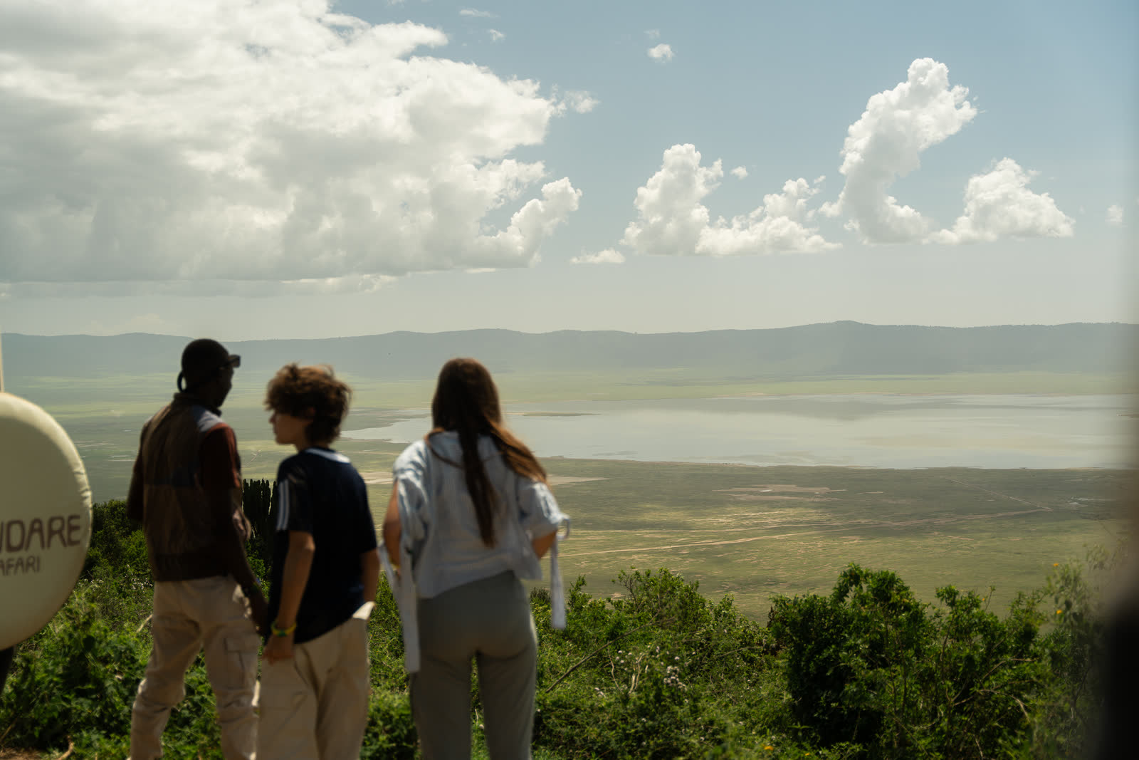 Travellers looking across a Tanzanian crater landscape.